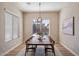 Bright dining room featuring a large window and a stylish modern chandelier at 2517 W Balao Dr, Phoenix, AZ 85085