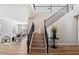 Elegant foyer featuring a staircase with rod iron detail and wood flooring at 2517 W Balao Dr, Phoenix, AZ 85085