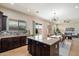 Stylish kitchen featuring dark wood cabinets, granite countertops and eat in island at 2517 W Balao Dr, Phoenix, AZ 85085