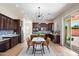 Open kitchen and dining area featuring dark cabinets and stylish light fixture at 2517 W Balao Dr, Phoenix, AZ 85085