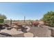 Lounge chairs sit around a fire pit in the backyard featuring low maintenance desert landscaping at 29534 N 128Th Ln, Peoria, AZ 85383