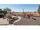 Relaxing backyard with desert landscaping, lounge seating and fire pit at 29534 N 128Th Ln, Peoria, AZ 85383