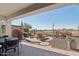 Spacious patio with lounge chairs and outdoor dining area with desert landscaping at 29534 N 128Th Ln, Peoria, AZ 85383