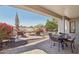 Covered outdoor space featuring lounge seating and fire pit, perfect for relaxation at 29534 N 128Th Ln, Peoria, AZ 85383