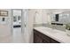 Modern bathroom with sleek vanity, glass-enclosed shower, and views into the adjacent bedroom at 29534 N 128Th Ln, Peoria, AZ 85383