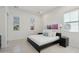 Bright bedroom with a dark frame bed, two windows with blinds, and neutral walls at 29534 N 128Th Ln, Peoria, AZ 85383