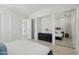 Bedroom featuring a closet with mirrored doors, dresser, and attached bath at 29534 N 128Th Ln, Peoria, AZ 85383