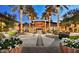 Upscale community center featuring outdoor seating, manicured flowers, and tall palm trees at 29534 N 128Th Ln, Peoria, AZ 85383