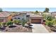 Inviting single-Gathering home showcasing beautiful desert landscaping and an attached two car garage at 29534 N 128Th Ln, Peoria, AZ 85383
