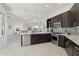 Modern kitchen featuring stainless steel appliances, an island, and an open layout to the living space at 29534 N 128Th Ln, Peoria, AZ 85383