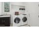 Functional laundry room featuring a washer and dryer, sink and built-in storage at 29534 N 128Th Ln, Peoria, AZ 85383