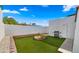 Cozy backyard features a charming fire pit, grill, and well-maintained artificial grass at 2629 S Country Club Way, Tempe, AZ 85282