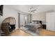 Well-lit bedroom featuring natural light, a comfortable bed, egg chair, fan, and cozy modern decor at 2629 S Country Club Way, Tempe, AZ 85282