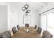 Elegant dining room featuring a large wooden table, stylish gray upholstered chairs, and a modern chandelier at 2629 S Country Club Way, Tempe, AZ 85282
