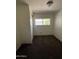 This bedroom features dark brown carpet, a window, and a closet at 2650 W Union Hills Dr # 272, Phoenix, AZ 85027