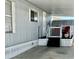 Exterior view of a shaded carport and front door with red chairs on the patio at 2650 W Union Hills Dr # 272, Phoenix, AZ 85027