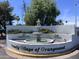 Community entrance with a water fountain and flower beds at 2650 W Union Hills Dr # 272, Phoenix, AZ 85027