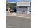 Charming single-story home featuring awnings, a covered porch, and inviting red flowerpots for enhanced curb appeal at 2650 W Union Hills Dr # 272, Phoenix, AZ 85027