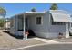 Attractive single-story home featuring awnings, a covered porch, and charming flowerpots adding warmth and curb appeal at 2650 W Union Hills Dr # 272, Phoenix, AZ 85027