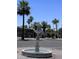 Outdoor decorative fountain surrounded by palm trees and lush landscaping on a sunny day at 2650 W Union Hills Dr # 272, Phoenix, AZ 85027