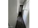 A hallway with plank floors leading to a bedroom door with a transom window at 2650 W Union Hills Dr # 272, Phoenix, AZ 85027