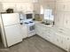 Bright kitchen with white appliances, white cabinets and drawers, and a double basin stainless steel sink at 2650 W Union Hills Dr # 272, Phoenix, AZ 85027