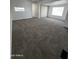Spacious living room with neutral carpet, bright white walls, and natural light, providing a comfortable and inviting atmosphere at 2650 W Union Hills Dr # 272, Phoenix, AZ 85027
