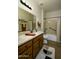 Neutral toned bathroom featuring a single sink vanity, a toilet, and a shower-tub combo with bronze fixtures at 2662 S Springwood Blvd # 341, Mesa, AZ 85209