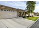 Street view of a single-story home featuring a two-car garage and well-manicured lawns at 2662 S Springwood Blvd # 341, Mesa, AZ 85209