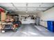Spacious garage with epoxy flooring, golf cart, and ample storage at 2662 S Springwood Blvd # 341, Mesa, AZ 85209