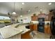 Open kitchen with granite countertops, breakfast bar, and wood cabinets, seamlessly connecting to the living area at 2662 S Springwood Blvd # 341, Mesa, AZ 85209