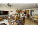 Spacious living area with a leather sofa, wooden coffee tables, breakfast bar, and adjacent dining area at 2662 S Springwood Blvd # 341, Mesa, AZ 85209