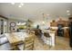 Open living space features a dining area, living room, and kitchen with a breakfast bar and wood cabinets at 2662 S Springwood Blvd # 341, Mesa, AZ 85209