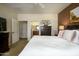Inviting main bedroom featuring a king bed, carpeted floors, a dresser, and an ensuite bathroom entrance at 2662 S Springwood Blvd # 341, Mesa, AZ 85209