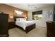 Cozy main bedroom with a king-size bed, stylish decor, and a view of the green outdoor scenery at 2662 S Springwood Blvd # 341, Mesa, AZ 85209