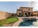 Backyard featuring a pool, putting green, desert landscape, and outdoor living, perfect for relaxation at 3234 E Marco Polo Rd, Phoenix, AZ 85050