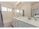 This bright bathroom features a double vanity with sleek countertops, tub, and modern fixtures at 3234 E Marco Polo Rd, Phoenix, AZ 85050