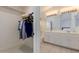This en suite bathroom features a double vanity and leads to a walk-in closet at 3234 E Marco Polo Rd, Phoenix, AZ 85050