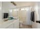 Clean bathroom with a shower-tub combo, white tile, and vanity with gray accents and ample lighting at 3234 E Marco Polo Rd, Phoenix, AZ 85050