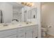 Bright bathroom featuring double vanity with sleek countertops and modern fixtures at 3234 E Marco Polo Rd, Phoenix, AZ 85050