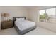 Bright bedroom with light carpet, white walls, and a large window offering lush backyard views at 3234 E Marco Polo Rd, Phoenix, AZ 85050