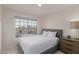 Sunlit bedroom featuring a comfy bed, side table, and large window with neighborhood views at 3234 E Marco Polo Rd, Phoenix, AZ 85050