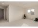 Spacious bonus room with neutral walls, bright carpet, and a large window letting in light at 3234 E Marco Polo Rd, Phoenix, AZ 85050
