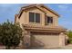 Exterior showcasing a two-car garage, stone accents, and neutral-colored stucco at 3234 E Marco Polo Rd, Phoenix, AZ 85050