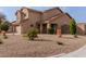 Inviting home featuring desert landscaping, stone accents, and a cozy front porch at 3234 E Marco Polo Rd, Phoenix, AZ 85050
