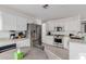 Bright kitchen boasts stainless steel appliances, ample counter space, and clean white cabinets at 3234 E Marco Polo Rd, Phoenix, AZ 85050