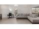 Bright living room features a modern couch, light colored floors, and a door leading to the outside at 3234 E Marco Polo Rd, Phoenix, AZ 85050