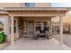 Covered patio with seating area, windows, and a view of the backyard at 3234 E Marco Polo Rd, Phoenix, AZ 85050