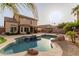 Backyard with a pool, covered patio, desert landscape, and room for recreation perfect for outdoor entertainment at 3234 E Marco Polo Rd, Phoenix, AZ 85050