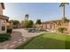 Resort style backyard with a pool, putting green, and desert landscaping at 3234 E Marco Polo Rd, Phoenix, AZ 85050